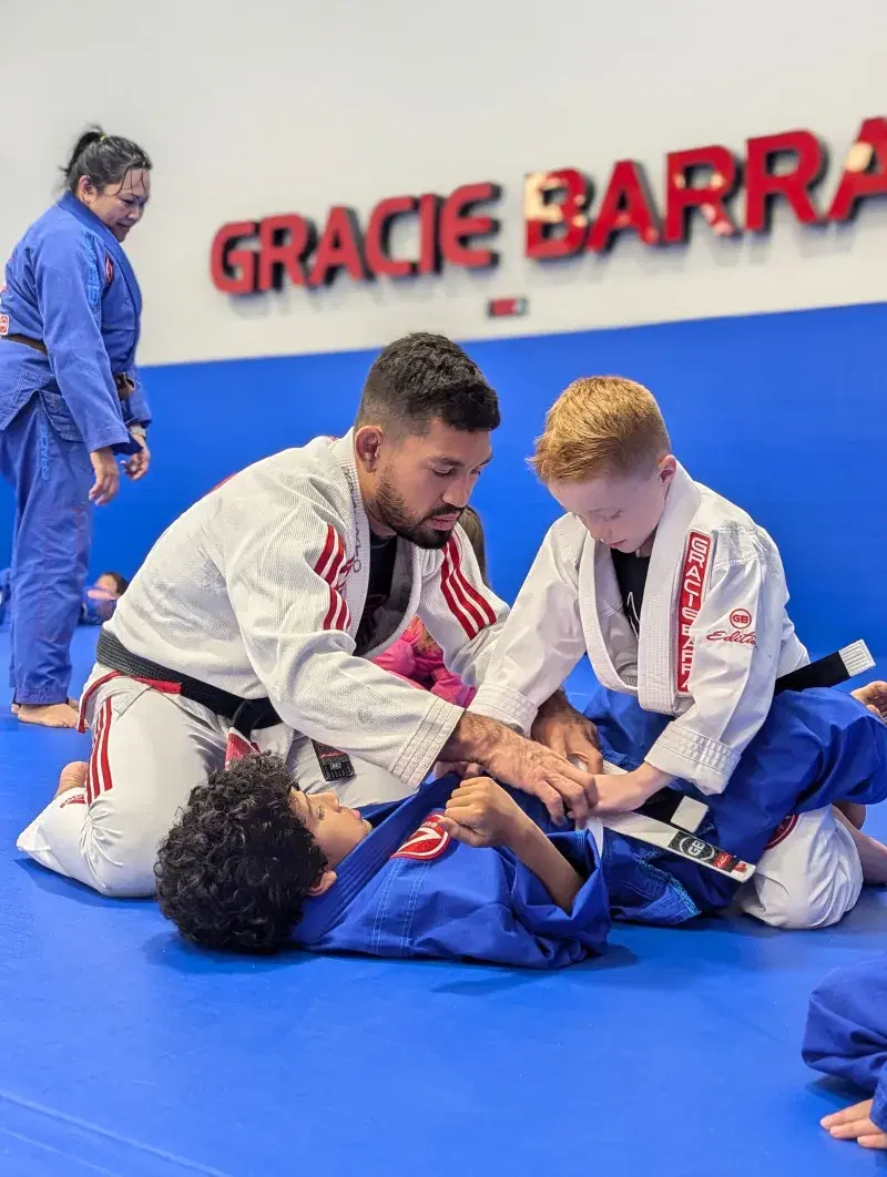 Head instructor coaching kids at Gracie Barra Al Khawaneej
